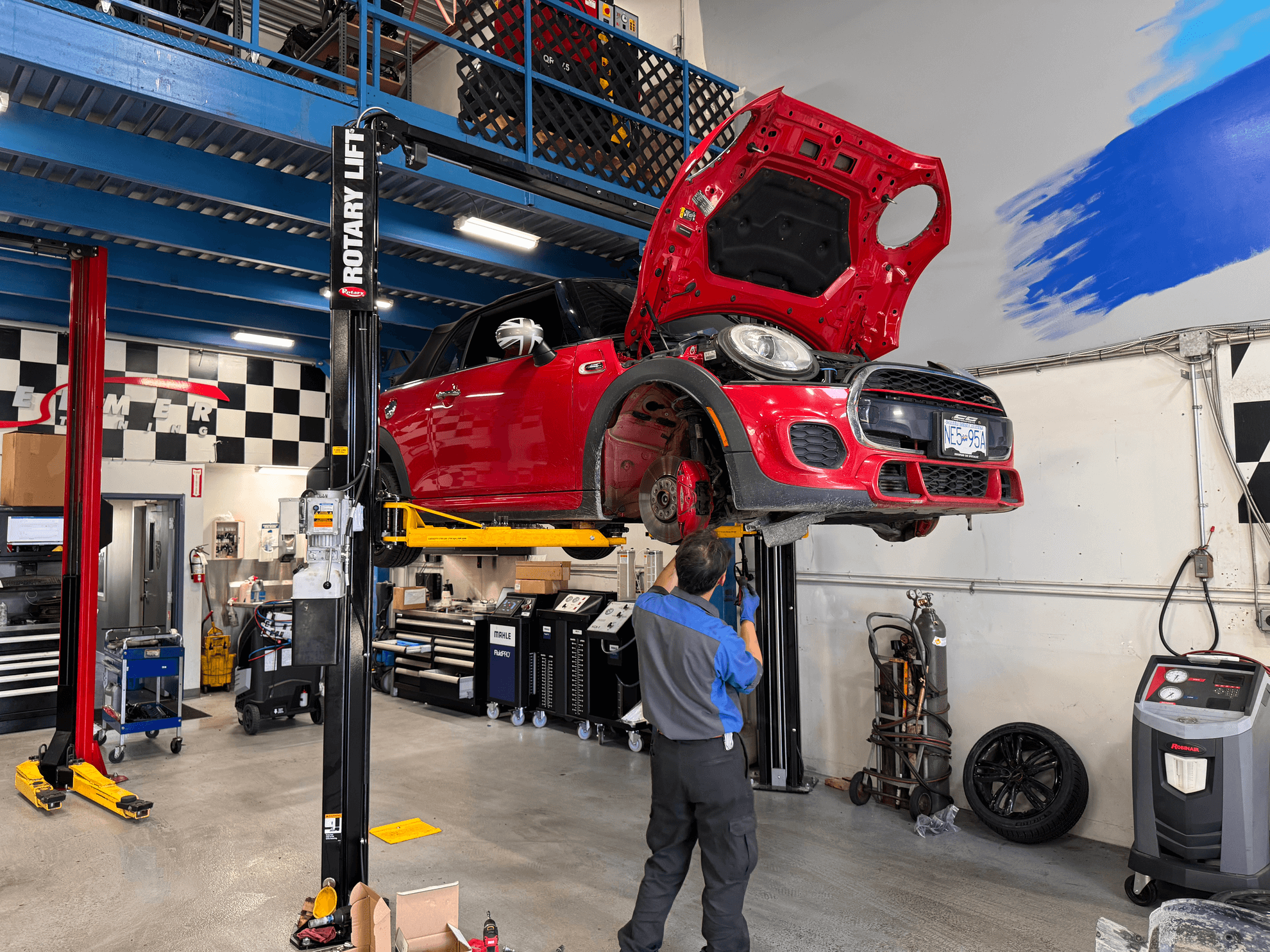 BMW Mini Technician servicing a red BMW Mini in the at CG Motorsports